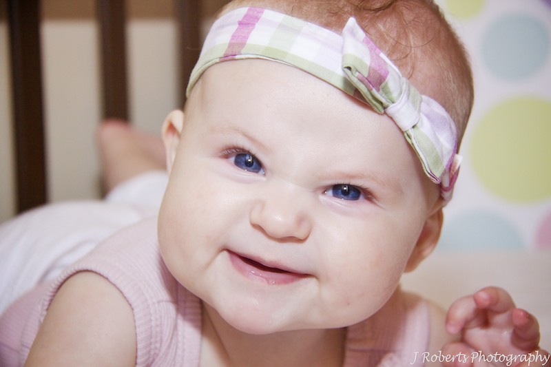 Cheeky little baby girl with headband - family portrait photography sydney